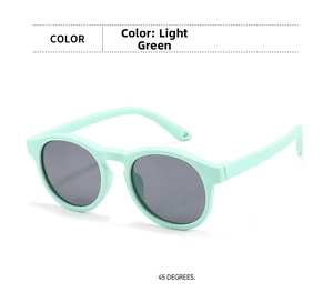 Detailed 45-degree view of light green silicone sunglasses for kids with grey lenses