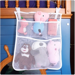 Multi-pocket white mesh hanging organizer with plush toys on a wooden bunk bed side