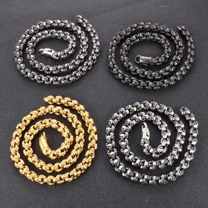 Gothic skull chain necklaces in silver, gold, and black finishes on dark background