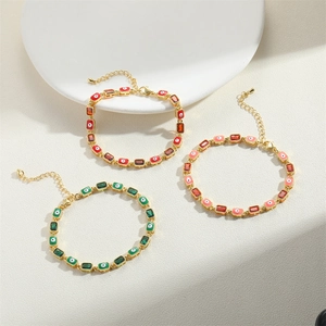 Detail of 14K gold plated bracelets with colorful zircon and evil eye enamel charms