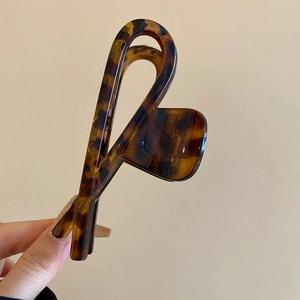 Close-up of tortoise leopard print hair claw with a minimalist geometric design