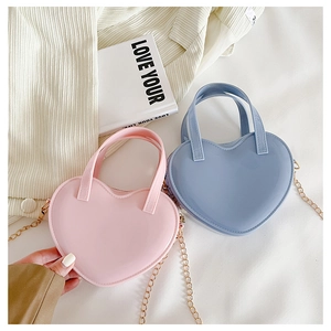 Detail view of heart-shaped mini jelly bags in pink and blue with metal chain straps