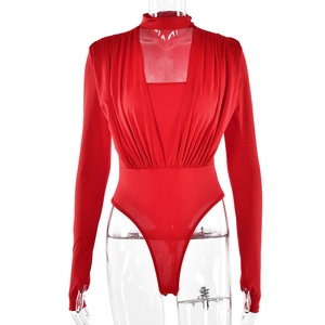 Close-up of red bodysuit featuring deep V-neck, pleated front details and finger hole cuffs