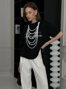 Black cotton t-shirt with pearl necklace print and precious deposits text design