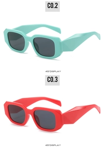 Detail of square sunglasses with geometric faceted arms in mint green and bright red