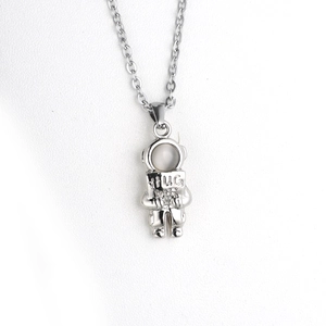 Detailed close-up of astronaut pendant with Hug Me engraving and opal stone inlay