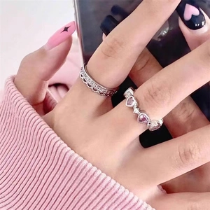 Elegant silver crown ring and pink heart gemstone stackable ring set on model's hand