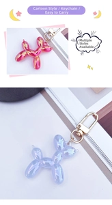Close-up of iridescent balloon dog keychains in pink and blue with gold metal clasps