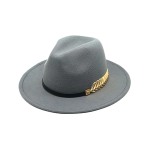 Detail of grey wool felt fedora with black ribbon and golden wheat metal buckle