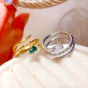Luxurious snake rings with pear-cut emerald and rectangle diamond in velvet jewelry box