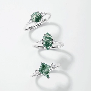 Three geometric S925 silver rings with green moss agate and zircon on white background