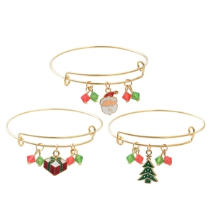 Three gold Christmas charm bracelets with Santa, gift box, and tree pendants