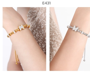 Detail of adjustable butterfly bracelet with sparkling zircon stones in gold and silver