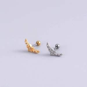 Detailed view of gold and silver winged star cartilage studs with sparkling zircon stones