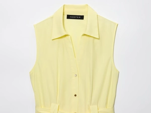 Detail of light yellow midi dress with V-neckline, lapel collar and metal buttons