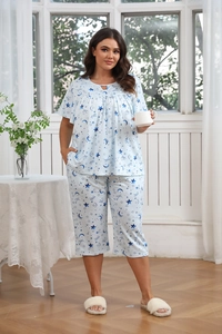 Detail of plus size sleepwear with star and moon prints and elastic waistband cropped pants