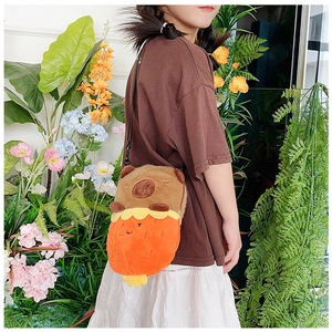 Detailed view of child wearing soft capybara plush crossbody bag in a garden setting