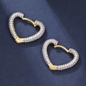 Luxurious gold heart hoop earrings with pavé set cubic zirconia on navy background