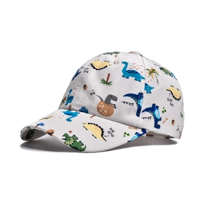 Detail of children's white baseball cap with colorful cartoon dinosaur and palm tree prints