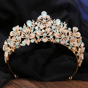 Detail of golden Baroque crown featuring blue crystals and sparkling rhinestones