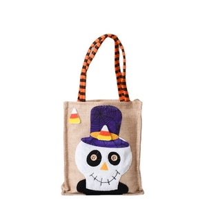 Halloween pumpkin skull gift bag with striped handle and candy corn decoration