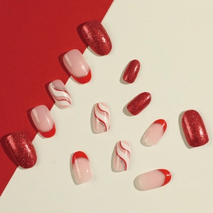 Festive red glitter press-on nails with silver sparkle and wavy bicolor patterns