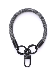 Close-up of woven gray fabric phone wrist strap with black metal swivel hook details