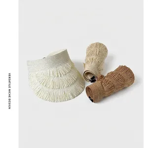 Foldable straw sun visor with fringe details in three natural colors for beach sun protection