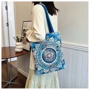 Detail view of the durable canvas material and blue mandala print on a shoulder tote bag