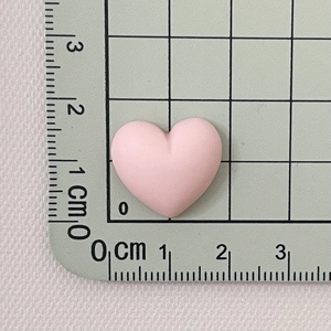 Detailed macro shot of a pink macaron heart resin accessory measuring 2cm in width