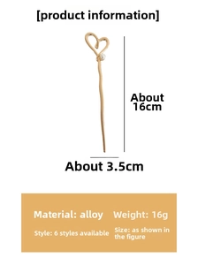Detail of golden heart hair pin with white pearl and specific dimension markings