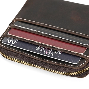 Close-up of vintage crazy horse leather coin purse with brass zipper and card slots