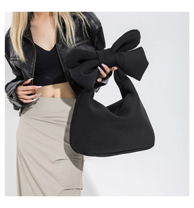 Fashionable black bow tote bag with large capacity shown in a professional studio setting
