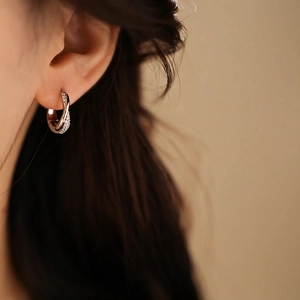 Elegant twisted silver hoop earrings for women with shimmering pavé zircon details