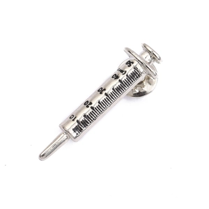 Detailed view of a silver syringe-shaped enamel pin with clear scale markings and clasp