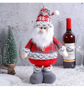 Detail of Santa Claus plush with red plaid fabric and a knitted high hat for Christmas decor