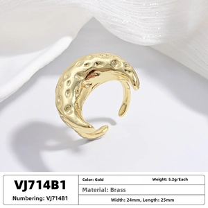 Macro view of gold moon-shaped brass ring with hammered texture and 25mm dimensions