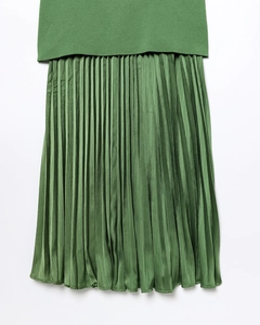 Détail du corsage en maille vert forêt et texture de la jupe plissée en satin
