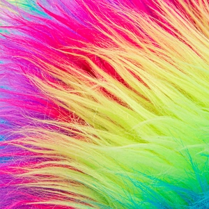 Macro detail of vibrant rainbow gradient faux fur with soft fluffy long pile texture