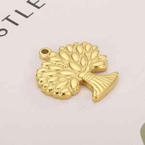 Macro detail of golden Tree of Life pendant featuring embossed leaves and textured trunk