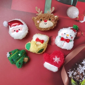 Detailed macro of six plush Christmas brooches featuring Santa, elk, and snowman on red background