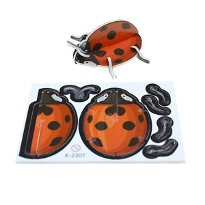 DIY 3D ladybug paper puzzle showing the assembled insect model and components board