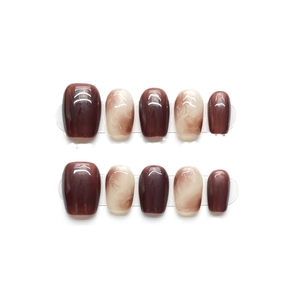 Short round amber caramel press-on nails with marble swirl and high-gloss finish