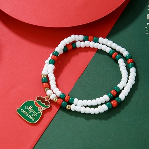 Close-up of a double-layered Christmas beaded bracelet with a festive gift bag charm