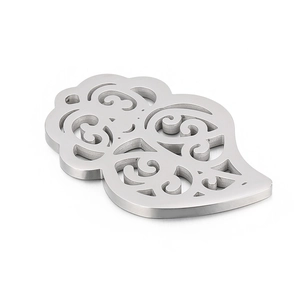 Hollow leaf pendant made of stainless steel with vintage filigree patterns on white background