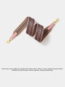 Close-up of 5cm wide pink woven shoulder strap with gold metal hooks for handbags