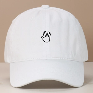 Detail view of palm embroidery on a vintage washed white cotton baseball cap with eyelets