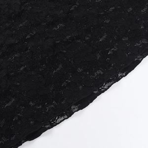 Macro shot of high-quality black lace fabric with intricate floral patterns and cutout details