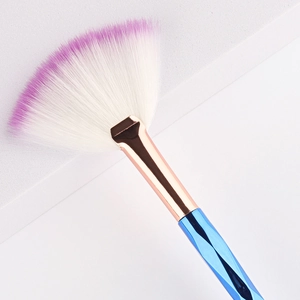 Macro shot of fan highlight brush with blue handle and purple gradient bristles
