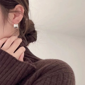 Minimalist 925 sterling silver curved stud earrings worn by model for elegant style